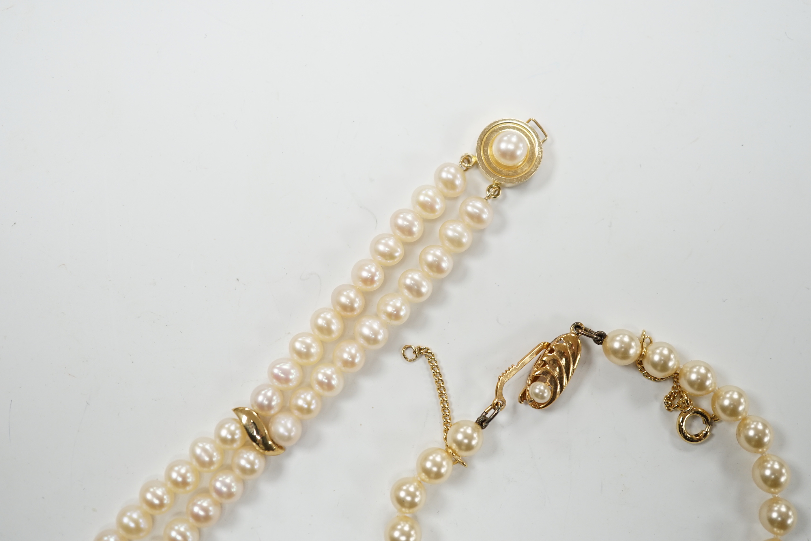 A modern double strand cultured pearl bracelet, with 14k clasp, 18cm, one other cultured pearl bracelet with 375 clasp and a simulated pearl bracelet.